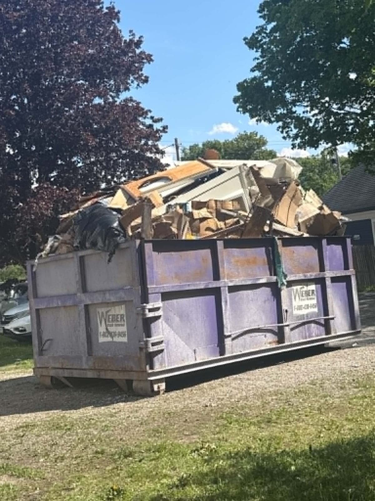 Loaded dumpster on a Poppa Mark job site